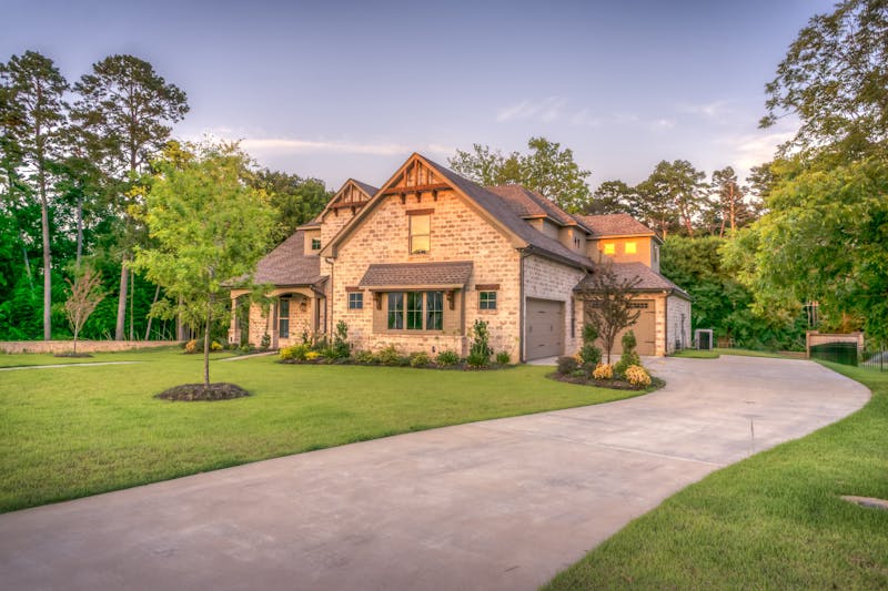 Stone estate with curved driveway and Georgia pine trees